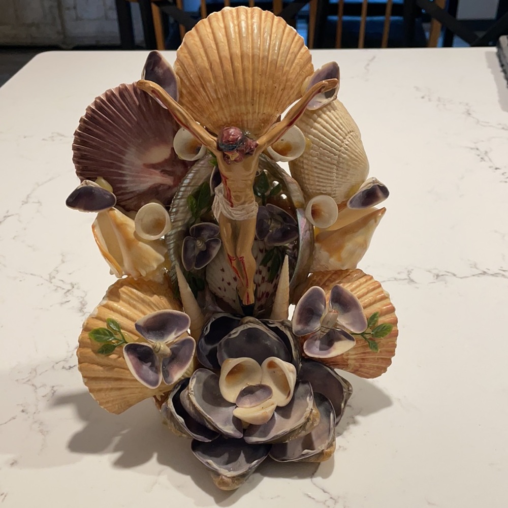 Beautiful religious shell creation with plastic Jesus. Cream, purple, tan colors